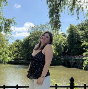 IMG_9407 2 photo of emma loftus with greenery and a river behind her